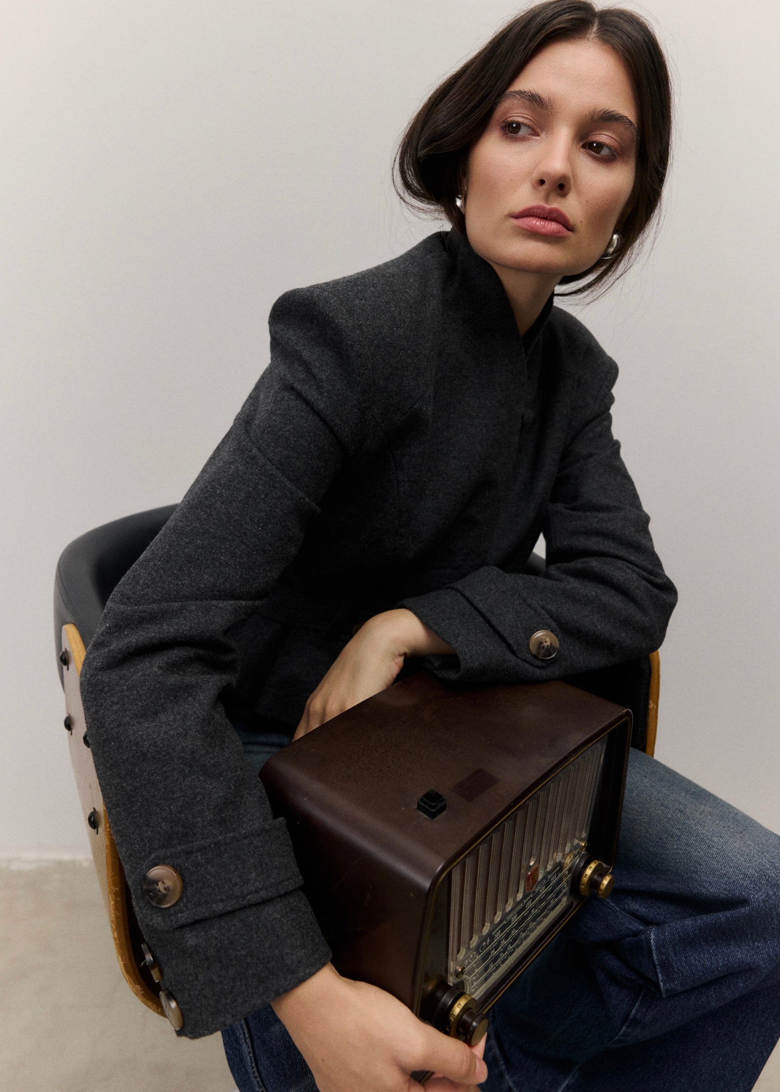 The Bruma Mandarin Collar Blazer in Grey Melange, seated close-up