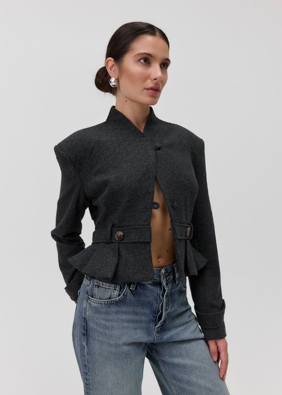 The Bruma Mandarin Collar Blazer in Grey Melange, worn open, detail of belted waist